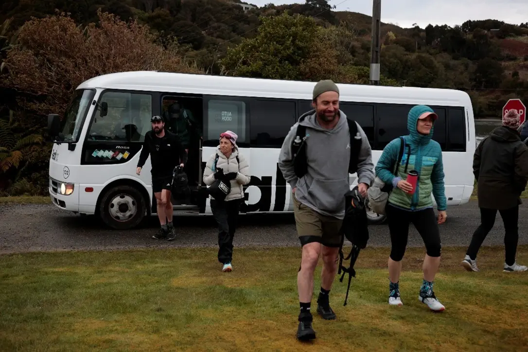 Runners stepping off the bus at the start area